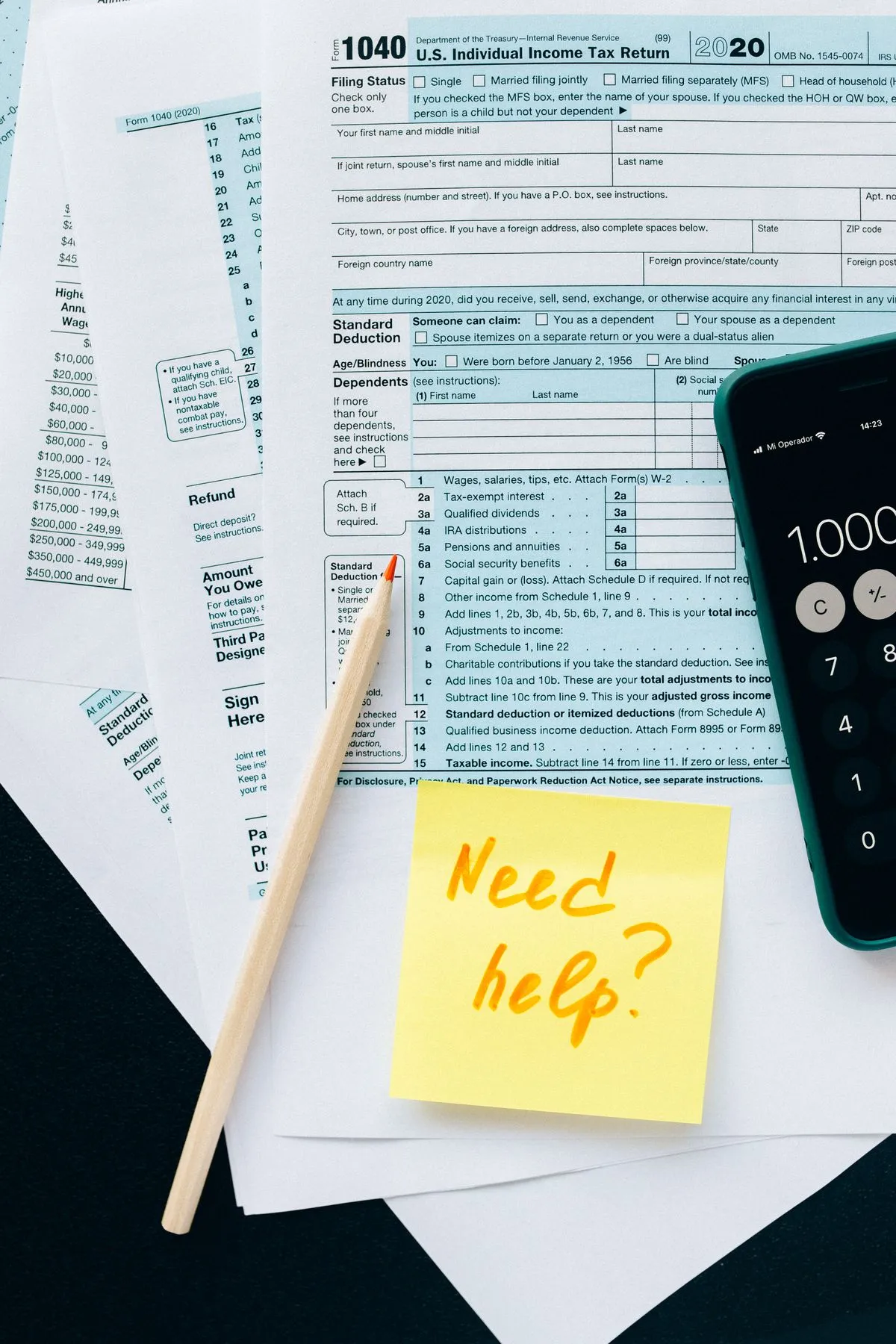 Federal tax forms and a calculator on a desk